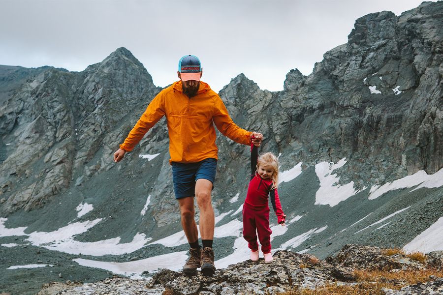 A father and daughter walking in a mountainous landscape, illustrating a long shot and the different types of shots in photography with Photobox.