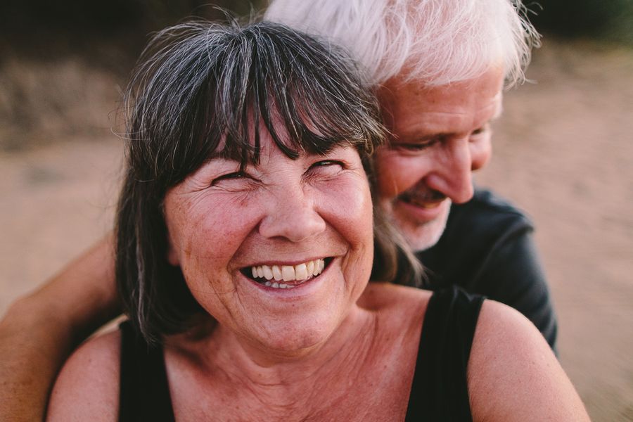 A close-up of an older couple embracing and smiling, showcasing a classic portrait shot and the different types of shots in photography with Photobox.