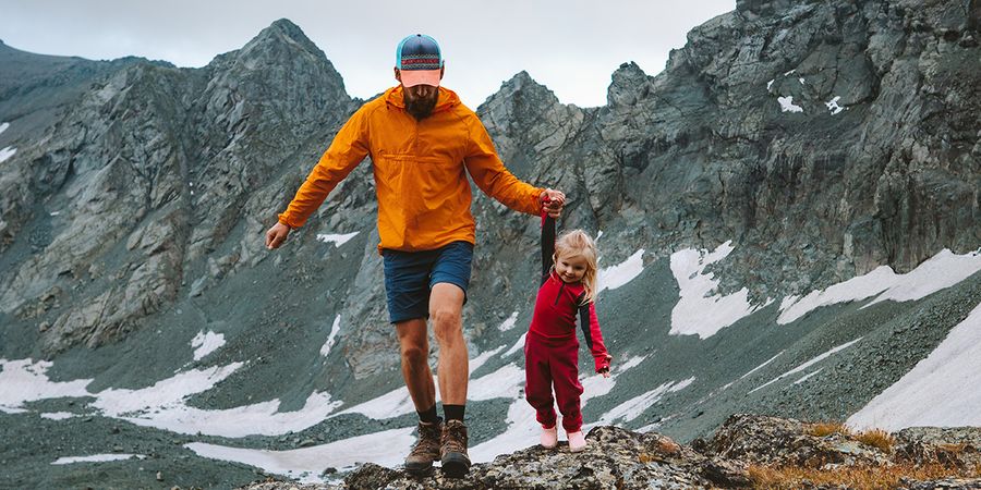 A father and daughter walking in a mountainous landscape, illustrating a long shot and the different types of shots in photography with Photobox.