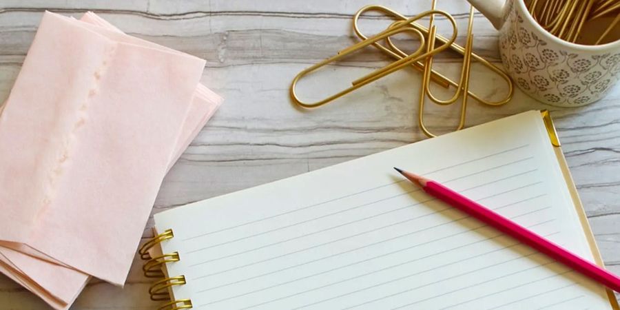 Guests writing words of wisdom on cards for an advice book, showing meaningful baby shower activities and baby shower ideas from Photobox.