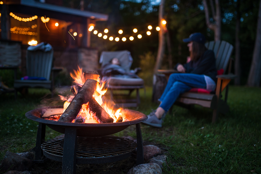 An outdoor fireplace outside a cabin showing a countryside retreat, a peaceful hen party idea for a relaxing hen do with Photobox.