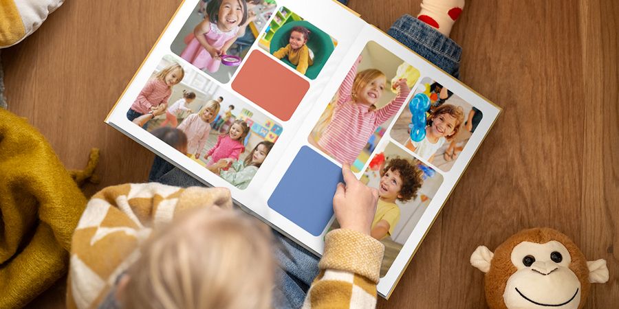 An open Photobox school photo book showing different photos of primary school children in class and in action, inspiring school photo albums, children’s school photo albums and school photo book ideas.