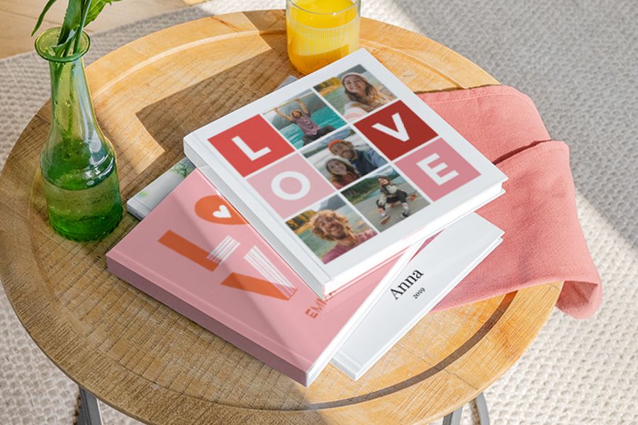 Personalised photobooks from Photobox using a love-themed template, displayed on a coffee table as unique valentines gifts for him and valentines day presents.