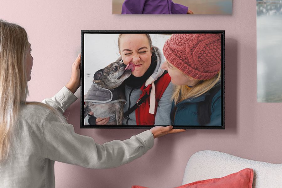 A woman holding a custom framed photo of a couple, perfect as a valentine gift ideas for him or one of those special valentines gifts for men that last forever.