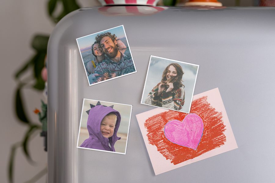 A selection of personalised photo magnets from Photobox on a fridge, serving as a thoughtful first valentine gift for boyfriend or unique valentines gifts for him.