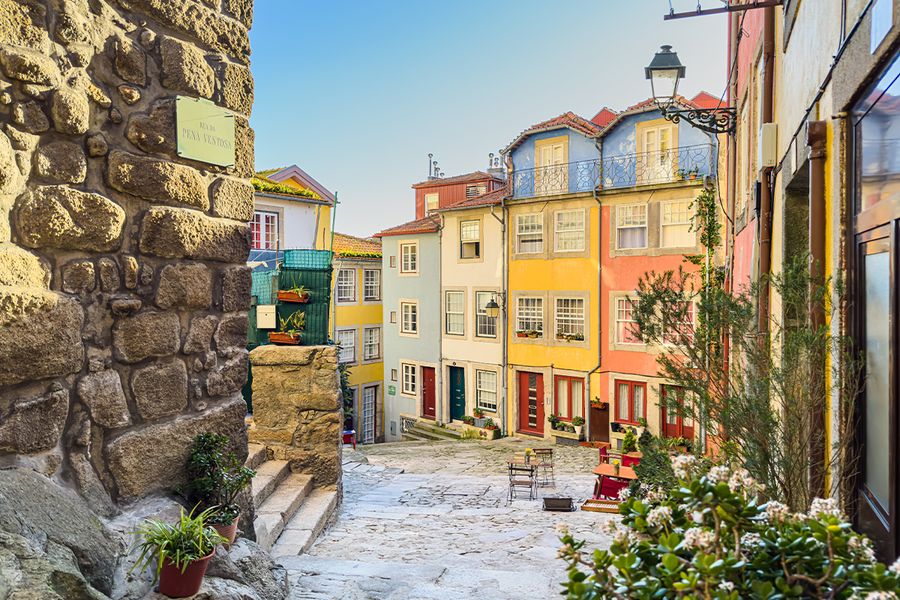 A picturesque cobbled street in Lisbon, Portugal, featuring colourful buildings, perfect for a romantic city break.