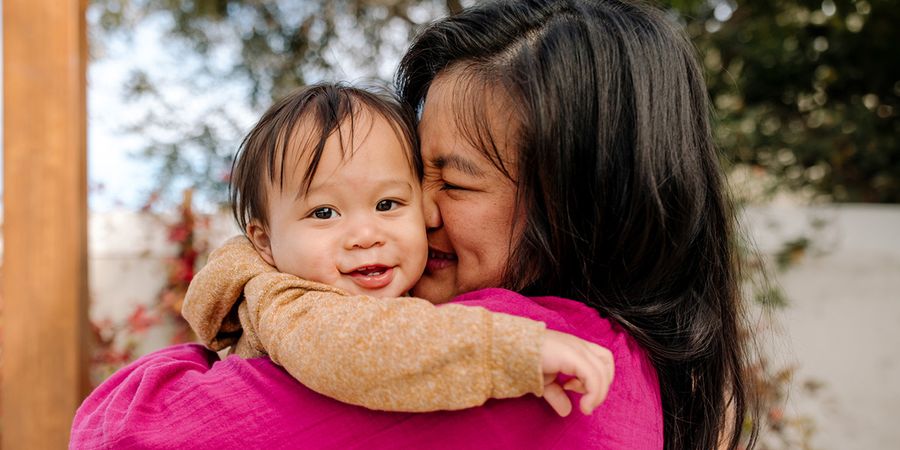 A smiling mother nuzzling her baby; a Photobox first mother's day gift idea for a new mum in 2026.