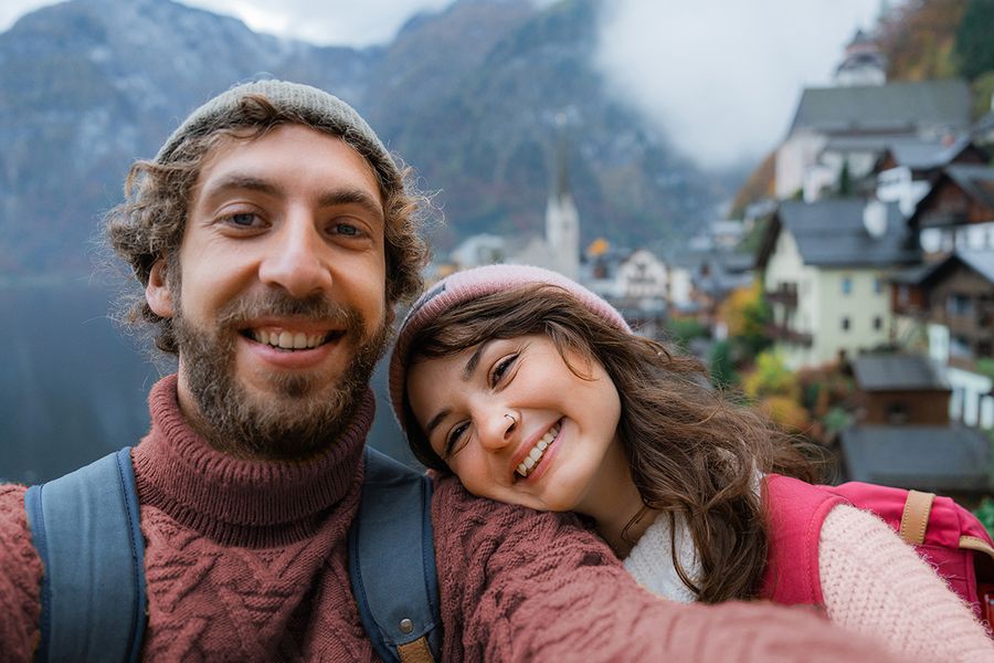 A smiling couple traveling and looking for romantic ideas for what to write for Valentine's Day to go with Valentine's day ideas and valentines gifts from Photobox.