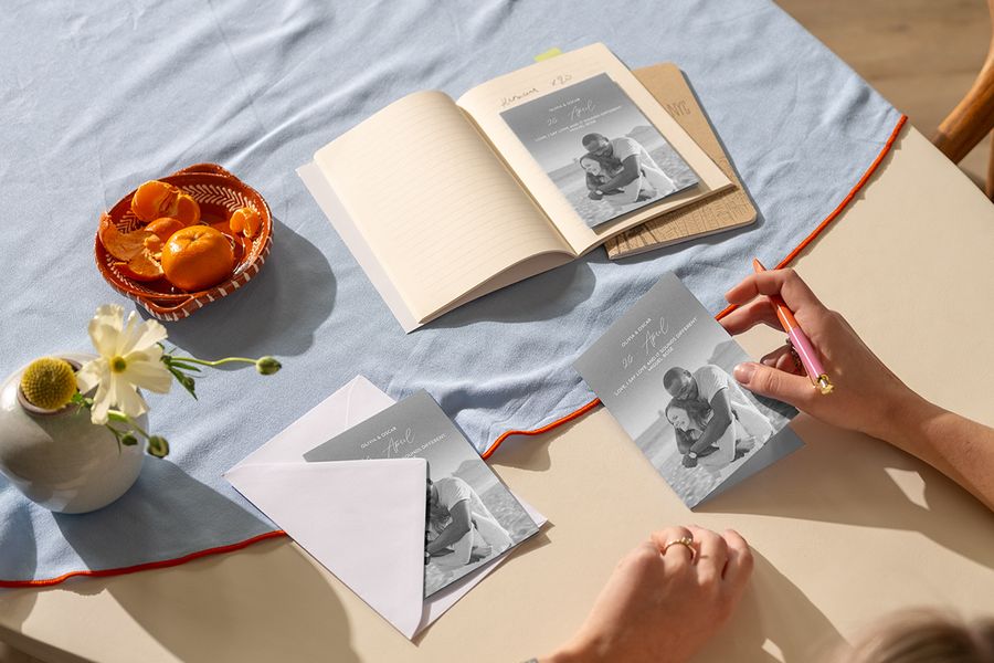 Photobox personalised wedding invitations on a coffee table ready to be written, inspiring wedding card messages and wedding invitation wording with meaningful song lyrics.