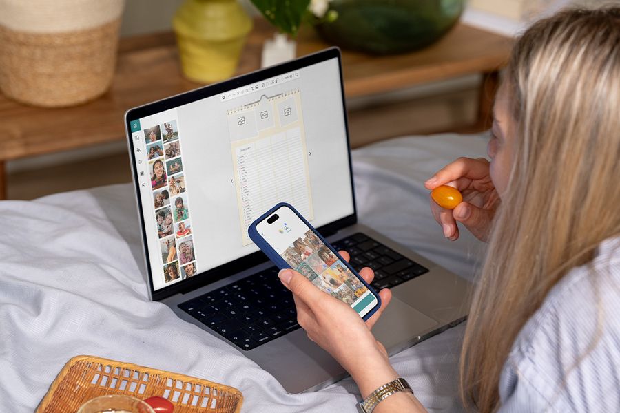 Woman using her laptop to make a personalised family planner using Photobox's easy editor