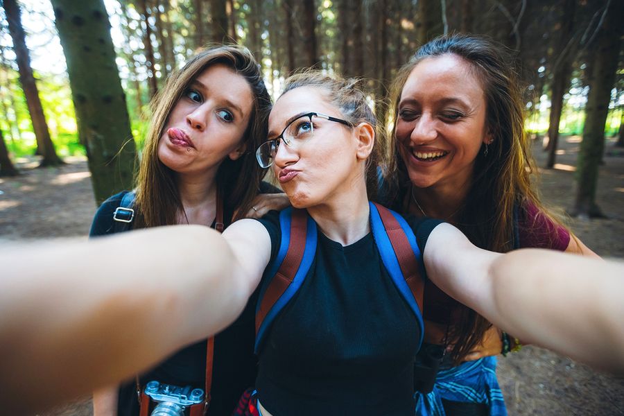 A fun group of three best friends taking a selfie for Photobox, showing that Valentine's Day is also for friends on Galentine's Day.