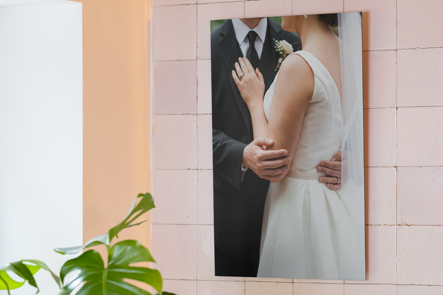 Wedding wall decor ideas from Photobox showing a high-quality aluminium print of a bride and groom embracing.