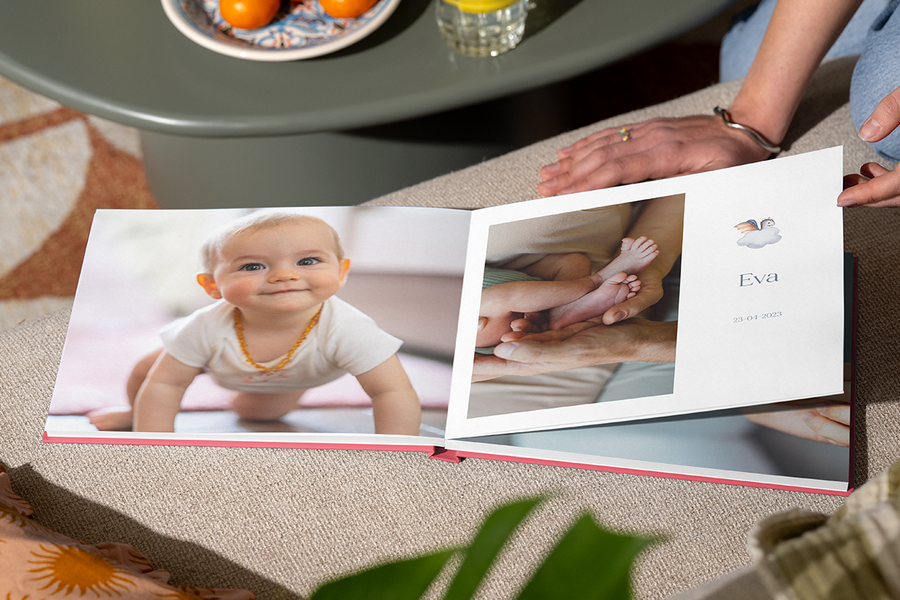 An open personalised first year photo album from Photobox.