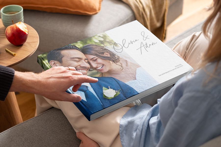 A beautiful wedding photobook from Photobox showing a couple on the cover, perfect for adding sentimental photobook quotes and romantic wedding captions.