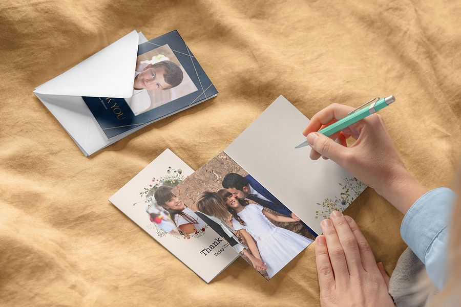 Someone preparing to decide what to write in a communion card using a variety of personalised holy communion cards from Photobox.