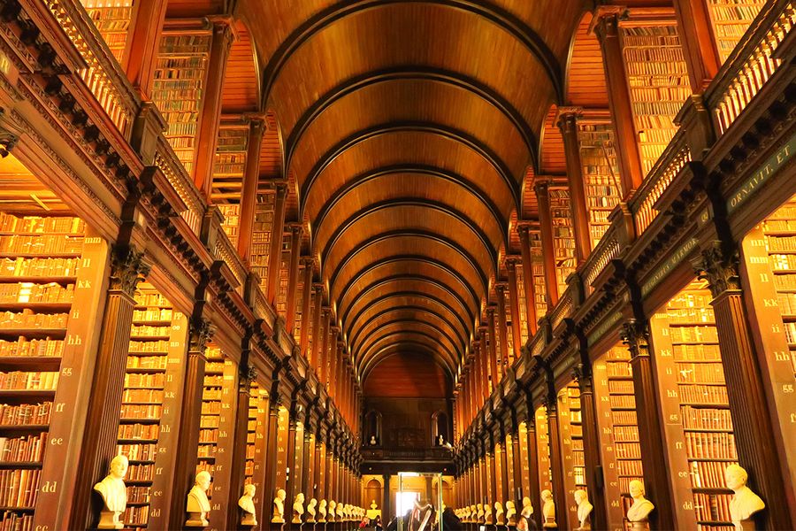 The Long Room at Trinity College Dublin, a historic 65-metre chamber with a barrel-vaulted ceiling and ancient books, perfect for literary travel with Photobox.