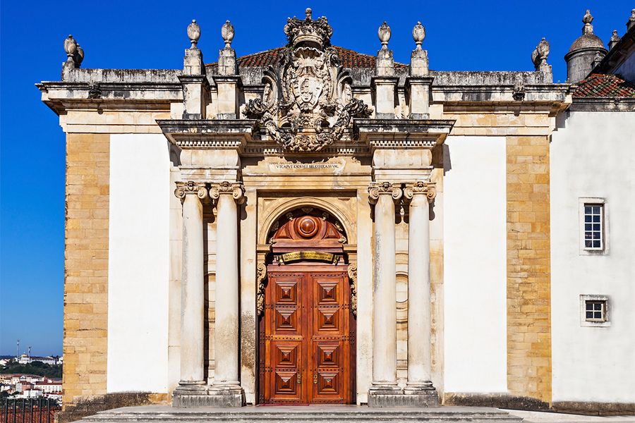 The Joanina Library at the University of Coimbra in Portugal, featuring ornate Baroque style and gold-leafed exotic wood shelves, a masterpiece for a literary travel bucket list with Photobox.