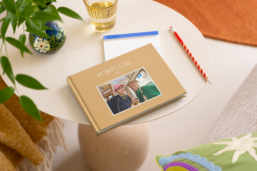 A personalised travel photobook on a table, showcasing photo gifts for Easter and unique personalised Easter gifts from Photobox.