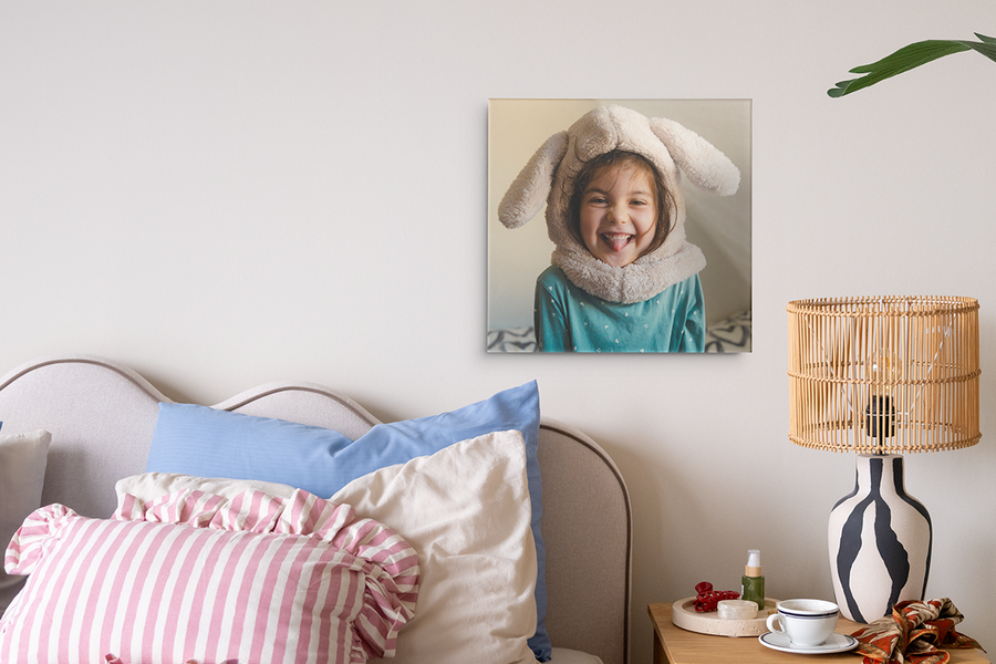 A personalised wall art piece featuring a girl displayed on a bedroom wall, ideal as a photo gift for Easter and a unique personalised Easter gift idea from Photobox.