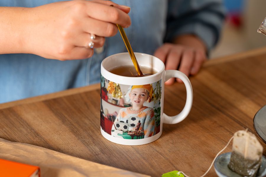A personalised mug from Photobox featuring a boy with a football cake, making it a great photo album birthday gift or birthday photo album gift add-on.