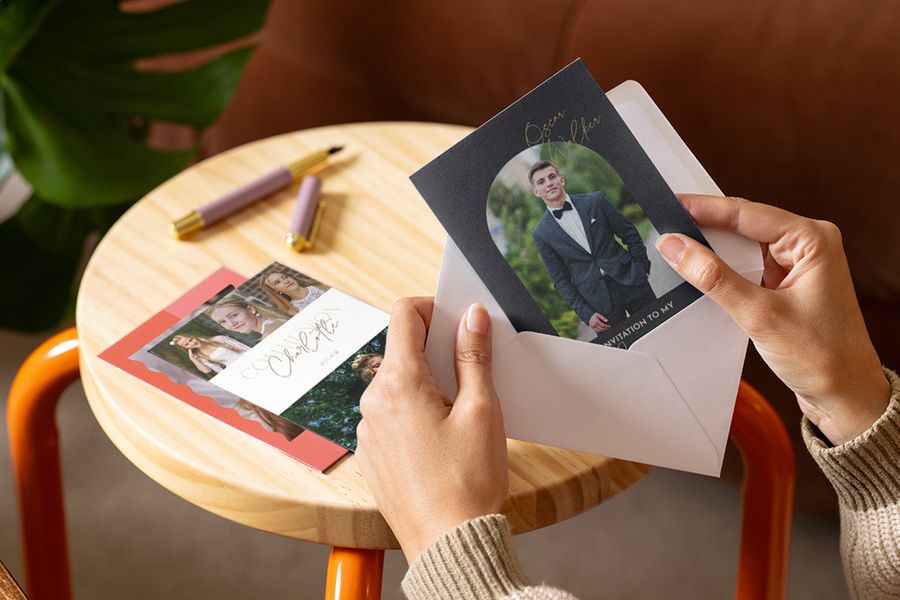 A person looking at a selection of personalised communion cards and invitations, part of the holy communion celebration ideas with Photobox.