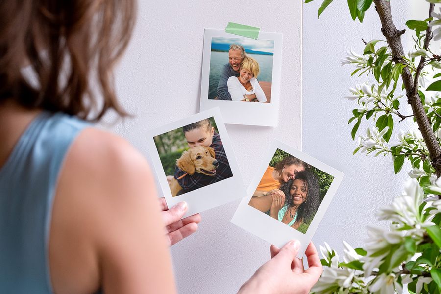 Different photo prints of happy couples displayed as part of a floral centerpiece, illustrating 2026 wedding trends and latest trends in wedding flowers with Photobox.