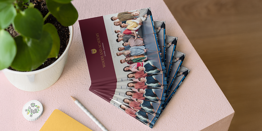 A Photobox school photo book showing a class of teenagers posing in front of a whiteboard, inspiring high school yearbooks, high school photo albums and school photo book ideas.