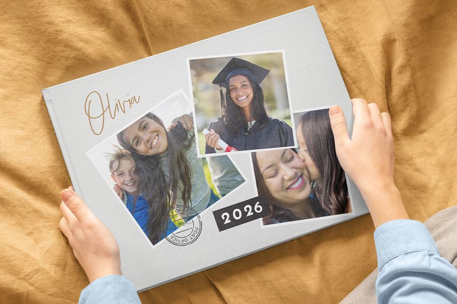 A 2026 Photobox graduation photo book with three photos on the cover, including a girl in a cap and gown alongside two childhood family photos, inspiring personalised graduation gifts and graduation photo book ideas.