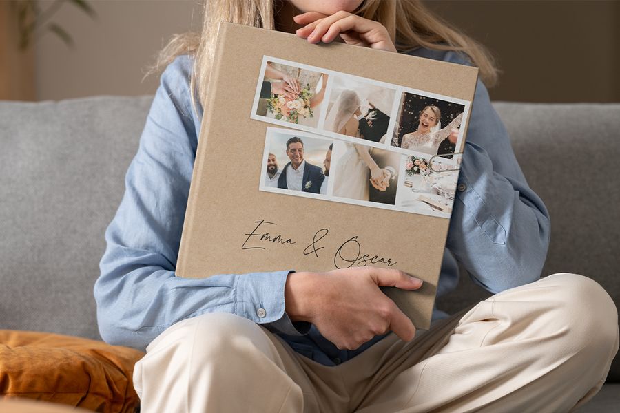 A woman holding a personalised Photobox wedding coffee table photo book in her lap, inspiring a wedding coffee table book and a custom coffee table photo book.
