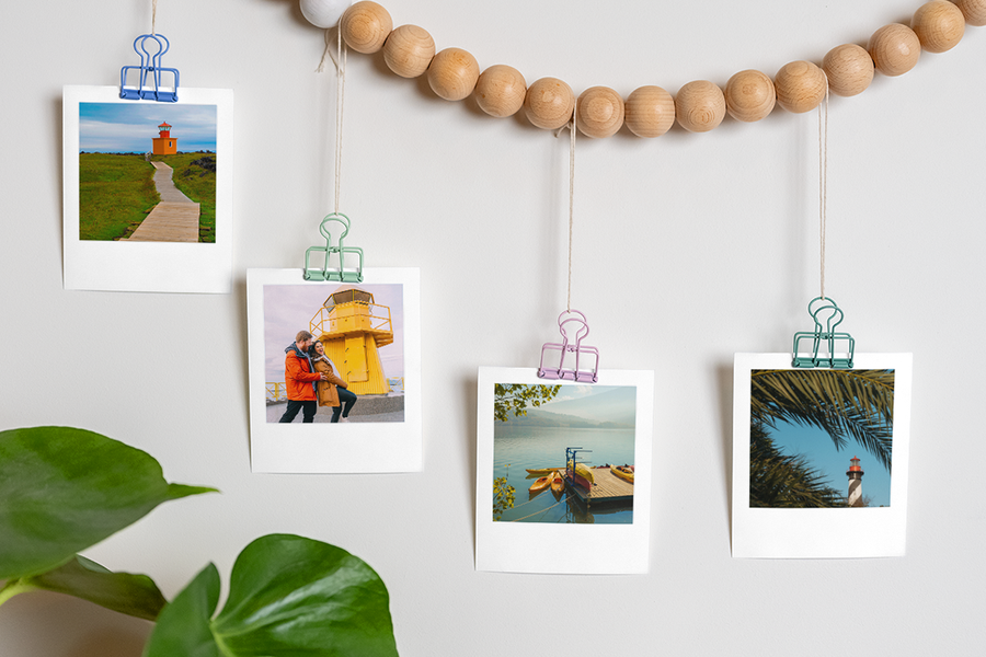 Lots of photo prints hanging from a string, illustrating a memory lane scavenger hunt and a creative proposal idea from Photobox.