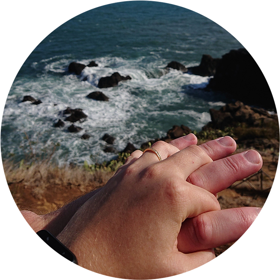 Two hands embracing by the sea in Madeira, one wearing an engagement ring, illustrating Kamilla’s romantic holiday proposal story.